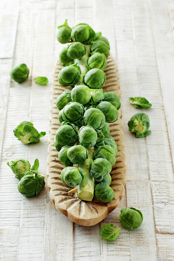 Brussels Sprouts On A Wooden Dish Photograph by Petr Gross