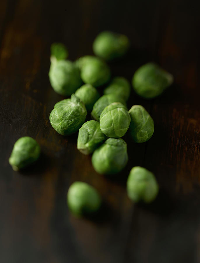 Brussels Sprouts On Wooden Table, Close Photograph by Westend61