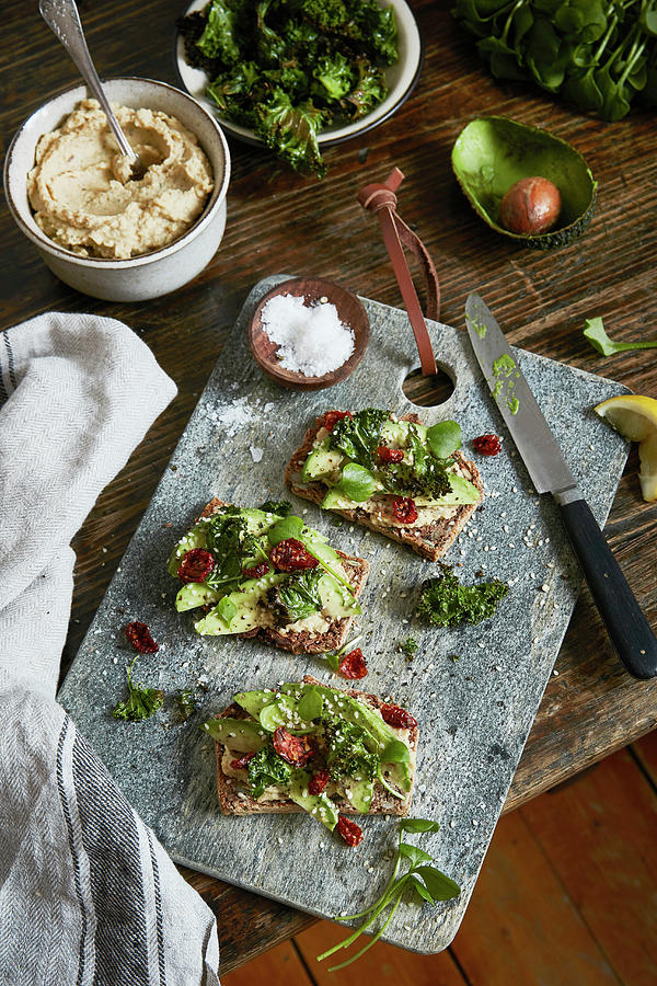 Buckwheet Bread With Avocado And Dried Tomtato On A Choppingboard. Photograph by Fanny Rdvik