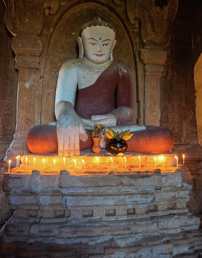 Buddha lit up by candles  Photograph by Ann Moore