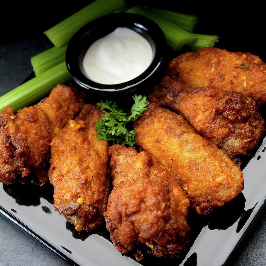Buffalo Chicken Wings With Garlic, Celery And Ranch Dressing Photograph by Paul Poplis