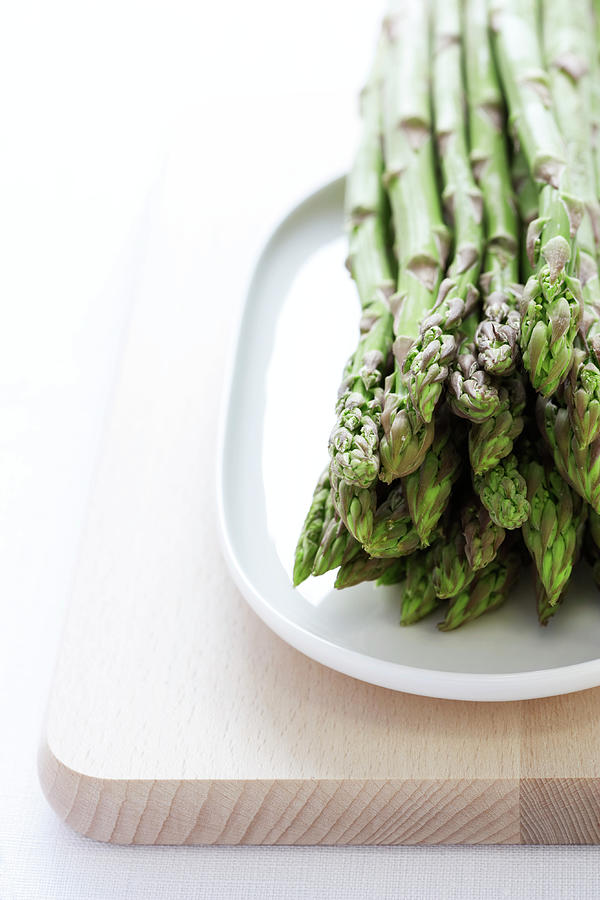 Bunch Of Asparagus On Plate, Close-up Photograph by Martin Poole