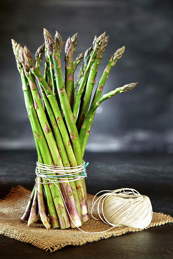 Bunch Of Asparagus Tied With Kitchen Twine, On A Piece Of Hemp Sack Photograph by Corina Daniela Obertas