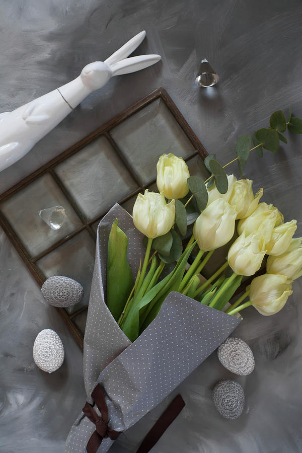 Bunch Of White Tulips In Grey Paper And Easter Eggs Photograph by Alicja Koll