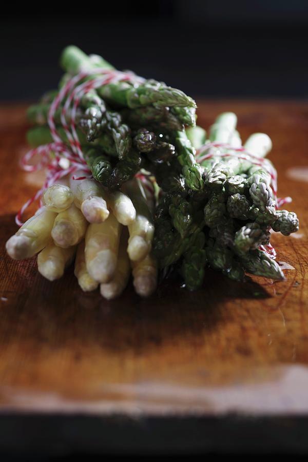 Bundles Of White And Green Asparagus On A Chopping Board Photograph by Frank Weymann