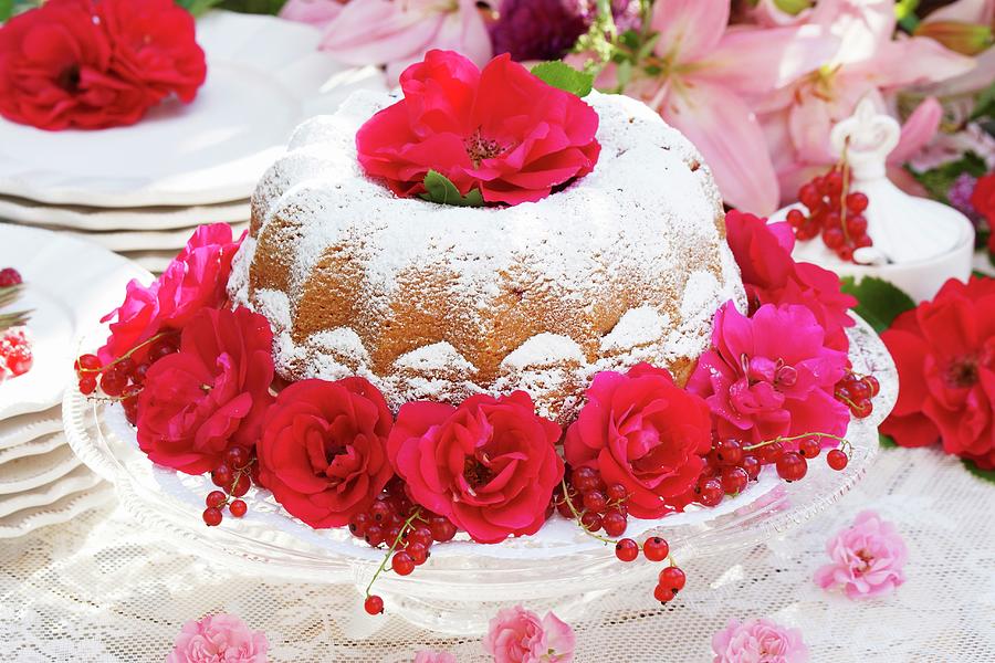 Bundt Cake With Icing Sugar, Rose Decorations And Redcurrants Photograph by Angelica Linnhoff