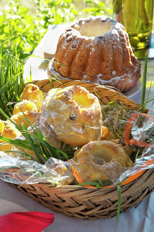 Bundt Cakes Of Various Sizes In Basket On Table In Summery Meadow Photograph by Angela Francisca Endress