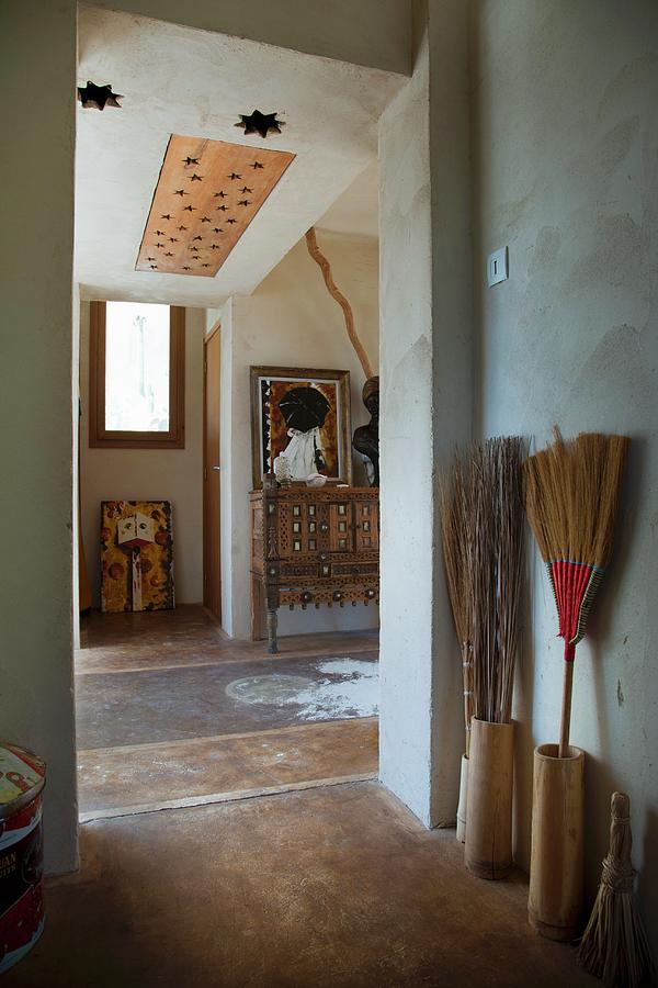 Bungalow Foyer With Painted Floor And Collection Of Besom Brooms Photograph by Christophe Madamour