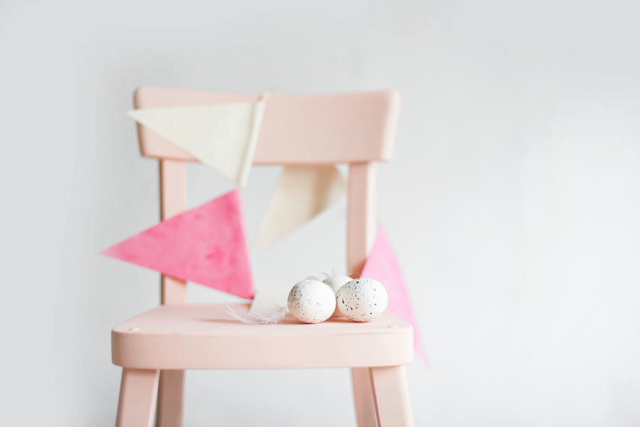 Bunting And Speckled Eggs On Chair Photograph by Alicja Koll