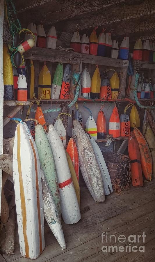Buoys in a sea shack Photograph by Mary Capriole