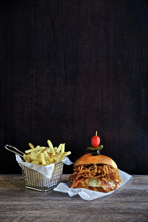 Bread Photograph - Burger With Cheese, Bacon Fried Onions And French Fries In A Frying Basket by Andre Baranowski