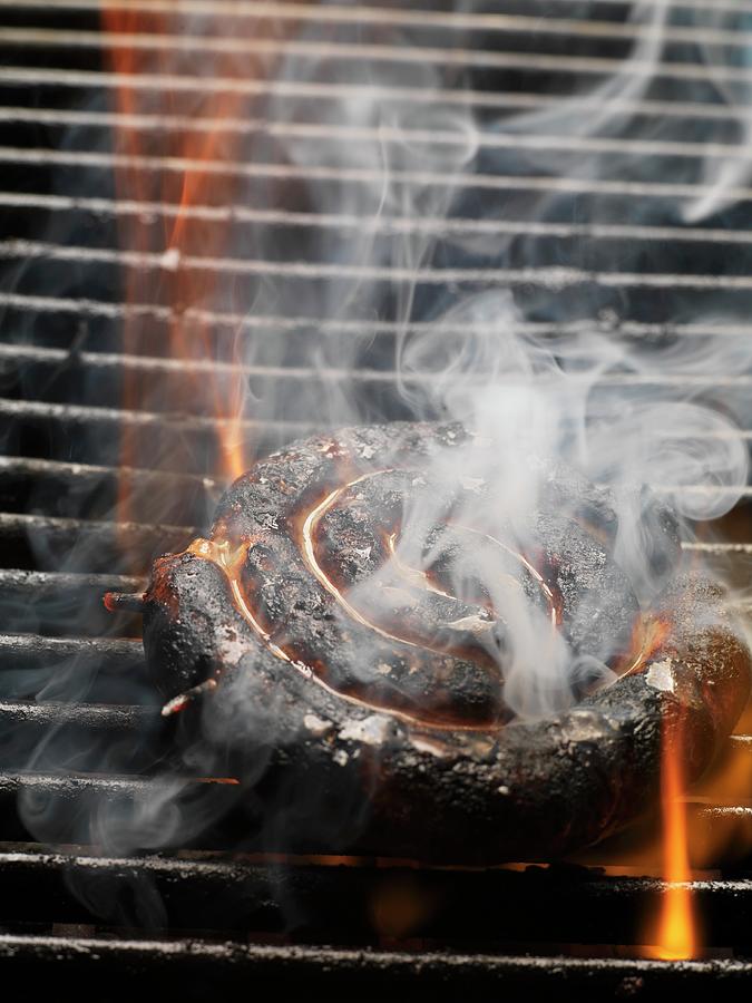 Burnt Sausage Spiral On The Barbecue Photograph by Eising Studio - Food Photo & Video