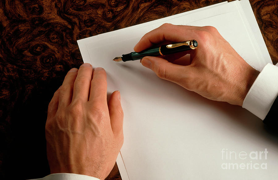Businessman Begins Writing On A Sheet Of Paper Photograph by Rosenfeld Images Ltd/science Photo Library