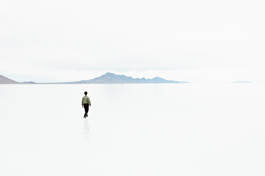 Businessman In Shallow Water In Photograph by Thomas Barwick