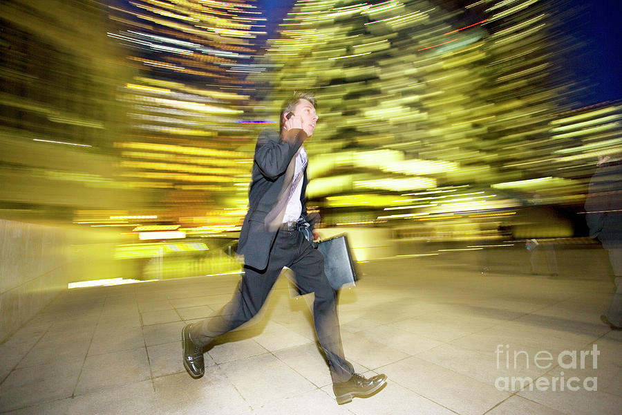 Businessman Leaving The Office At Night Photograph by Conceptual Images/science Photo Library