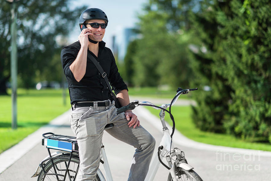 Businessman On Electric Bicycle Talking On The Phone Photograph by Microgen Images/science Photo Library