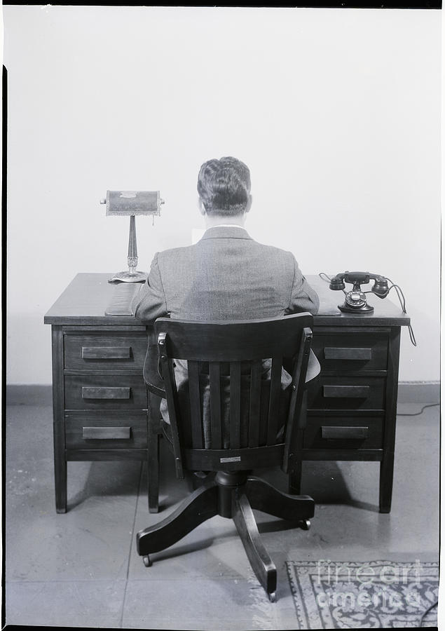 Businessman Sitting At A Desk Photograph by Bettmann