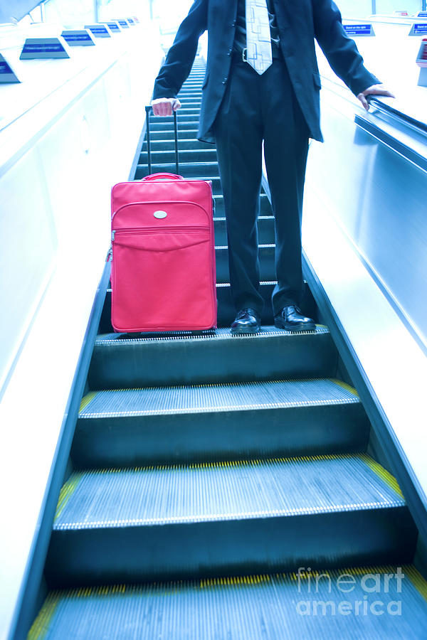 Businessman Travelling Down An Escalator Photograph by Conceptual Images/science Photo Library
