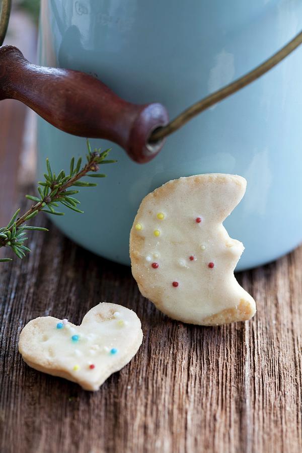 Butter Biscuits Decorated With Coloured Sprinkles In Front Of A Milk Churn Photograph by Martina Schindler