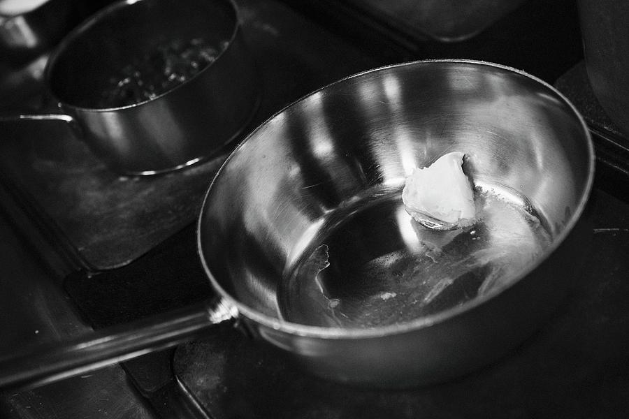 Butter Melting In A Saucepan Photograph by Alex Hinchcliffe