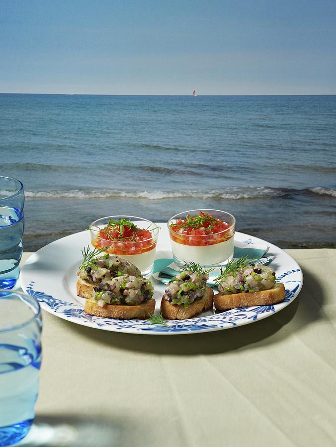 Buttermilk Mousse And Slices Of Bread Topped With Soused Herring Tartar On A Table Overlooking The Sea Photograph by Luzia Ellert