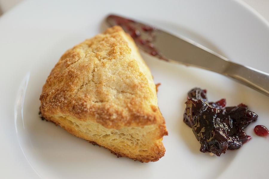 Buttermilk Scone With Black Cherry Confiture On A White Plate Photograph by Albert P Macdonald