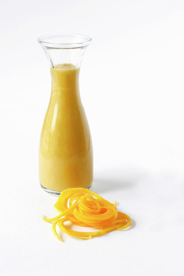 Butternut Soup In A Glass Bottle With Butternut Noodles And Space For Text Photograph by Ev Thomas