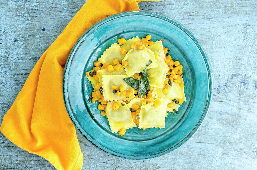 Butternut Squash Filled Ravioli Pasta With Roasted Butternut Squash And Sage Leaves In A Blue Plate Photograph by Giulia Verdinelli Photography