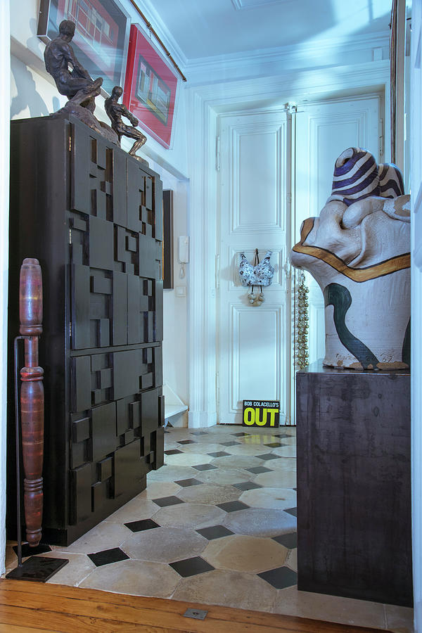 Cabinet With Structured Front And Collection Of Sculptures In Foyer Photograph by Christophe Madamour