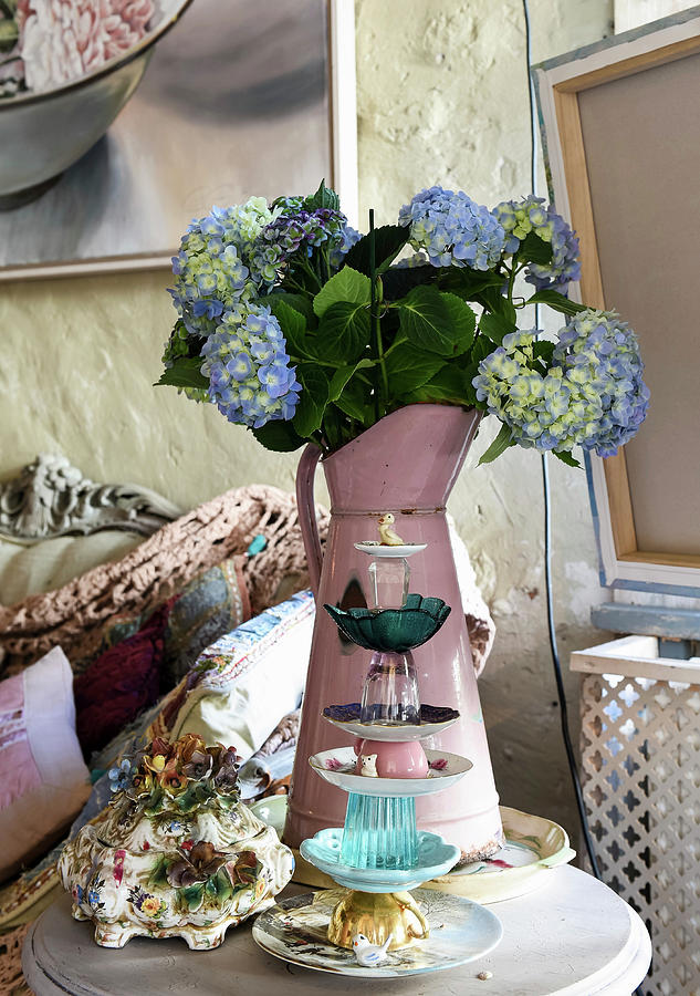 Cake Stand Made From Stacked Crockery In Front Of Blue Hydrangeas In Metal Jug Photograph by Loving Brocante