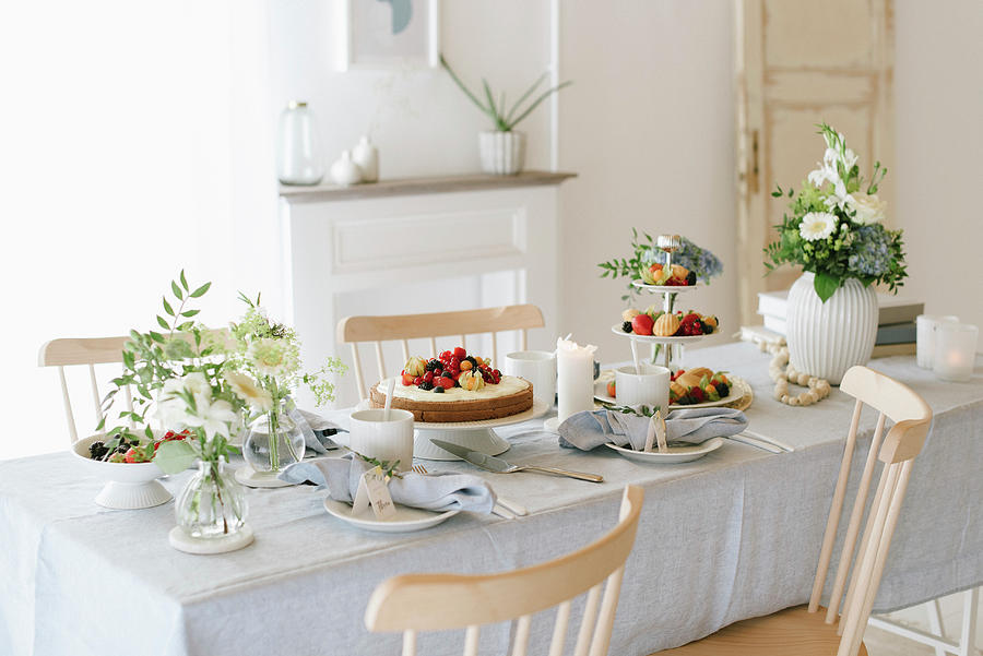 Cakes, Berries And Madeleines On Table Festively Set For Afternoon Coffee Photograph by Katja Heil