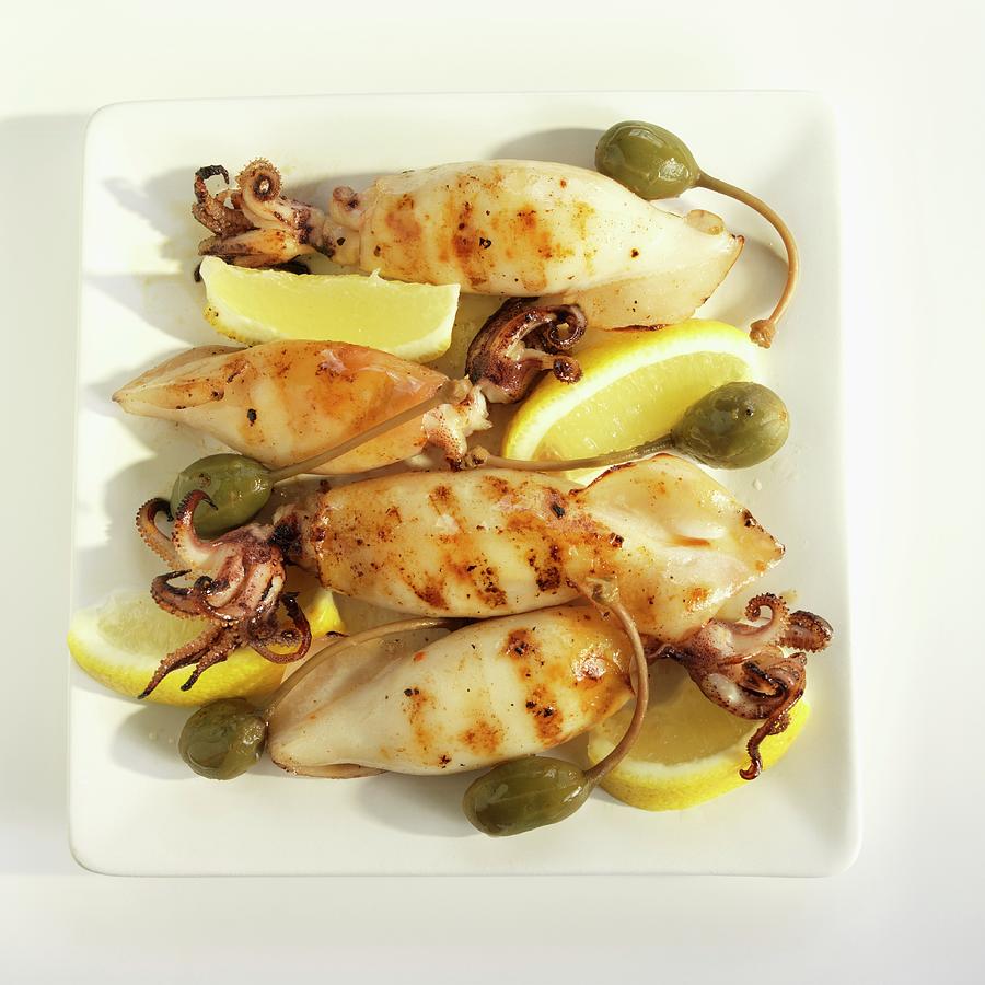 Calamari Grilled With Lemons And Capers Photograph by Paul Poplis