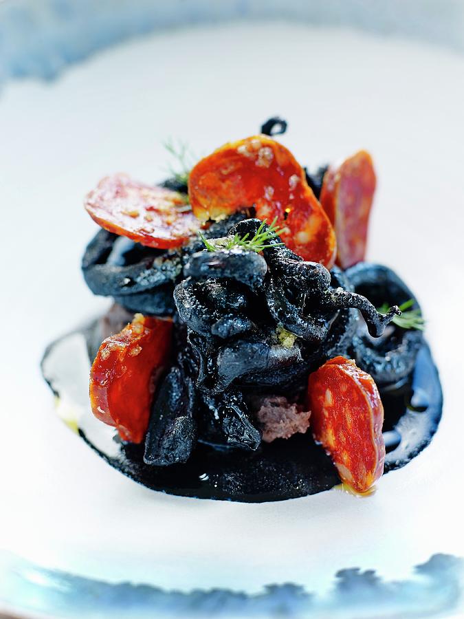 Calamay Rings In Squid Ink With Chorizo Photograph by Amiel