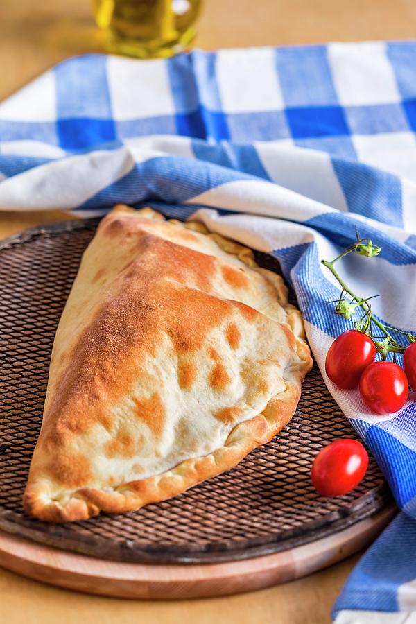 Calzone Caprese pizza Pocket With Tomatoes And Mozzarella, Italy Photograph by Lukasz Zandecki