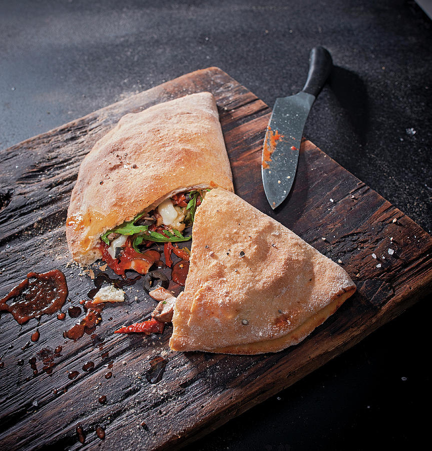 Calzone With Porcini Mushrooms, Olives, Sun-dried Tomatoes And Scamorza Photograph by Torri Tre