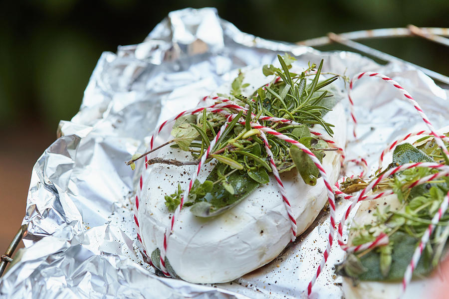 Camembert With Fresh Herbs In Aluminium Foil Photograph by Brigitte Sporrer