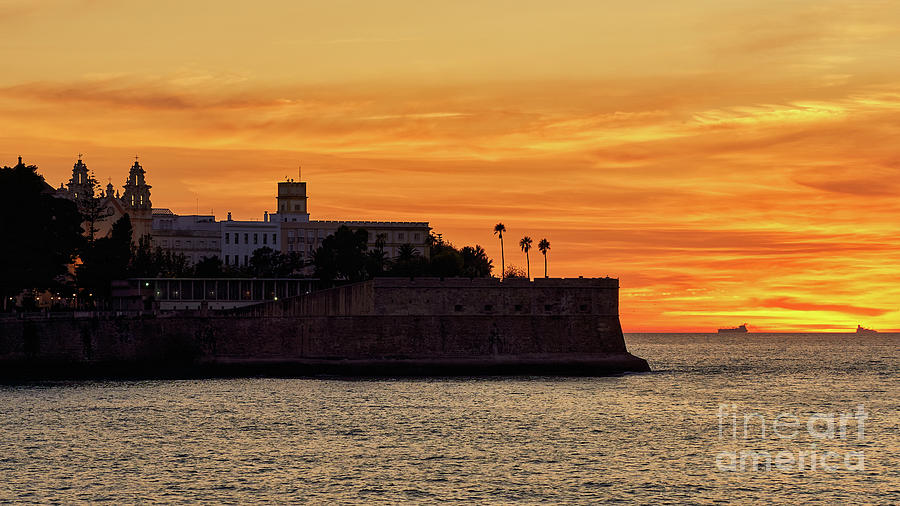 Candelaria Fortress Silhouette at Sunset against Orange Sky Photograph by Pablo Avanzini