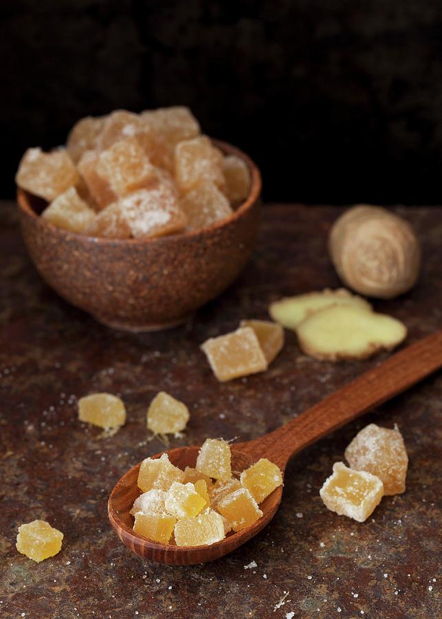 Candied Ginger In A Bowl And On A Wooden Spoon Photograph by Jane Saunders