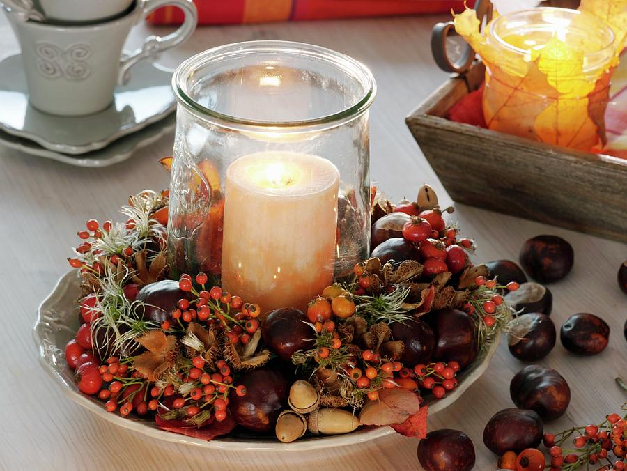 Candle In Glass In Wreath Of Rose Hips, Chestnuts And Acorns Photograph by Friedrich Strauss