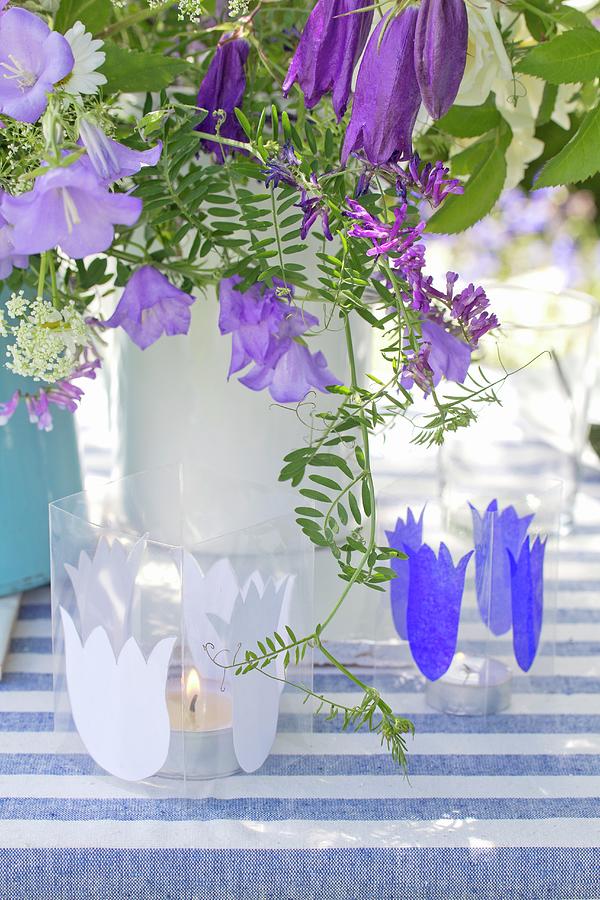 Candle Lanterns Decorated With Paper Bellflower Silhouettes In Front Of Vase Of Flowers Photograph by Angela Francisca Endress