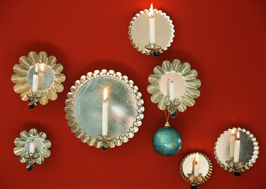 Candles With Holders Attached To Baking Tins As Wall Decoration Photograph by Julia Hoersch