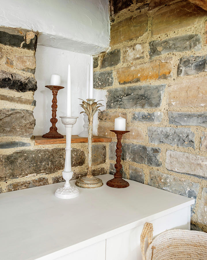 Candlesticks On Low Sideboard In Rustic Niche Photograph by Stuart Cox