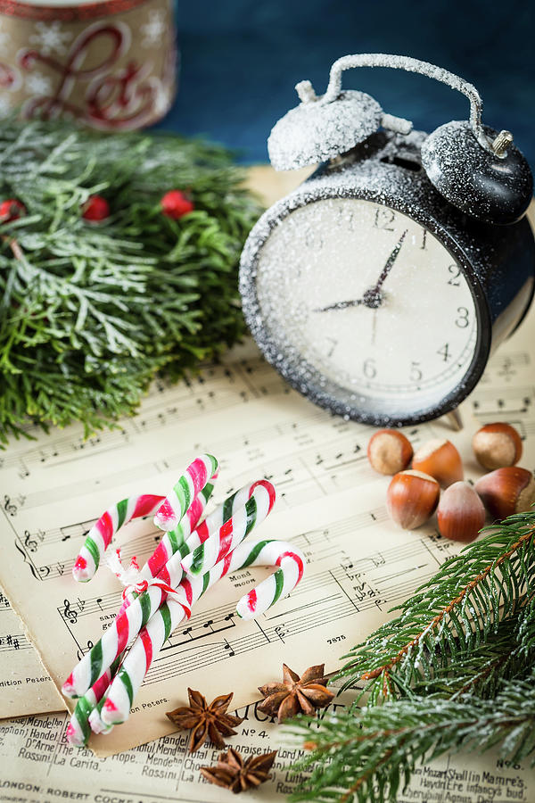 Candy Canes, Hazelnuts And Alarm Clock On Music Sheet Photograph by Anna Lukasiewicz