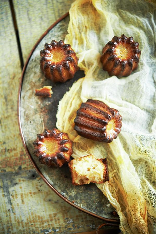 Caneles And Cheese Cloth On A Platter Photograph by Rannells, Greg