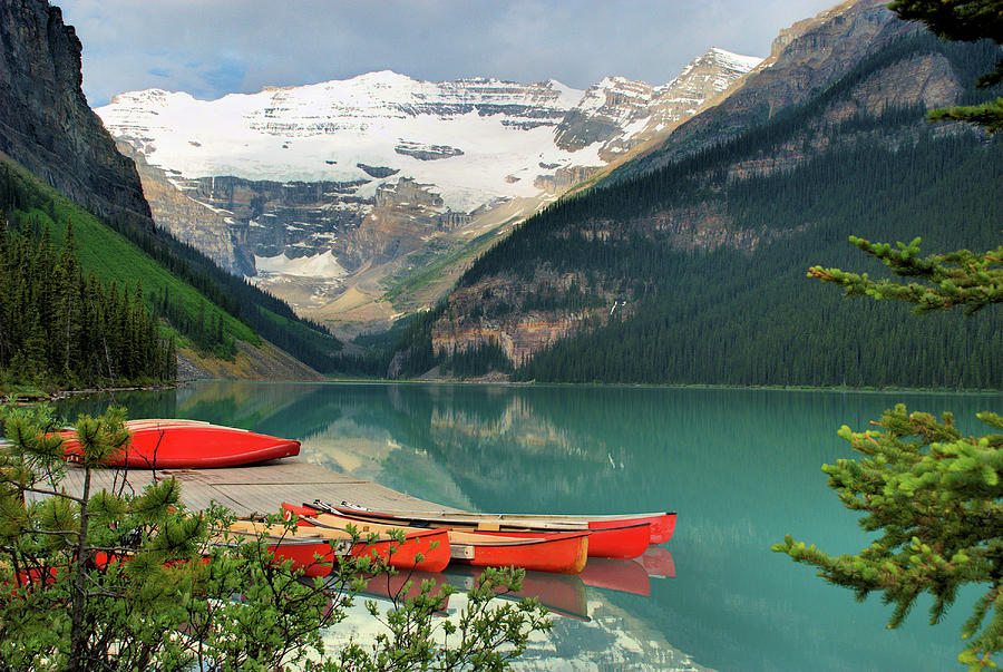 Canoes On Lake Louise Photograph by Kimberly Whitaker