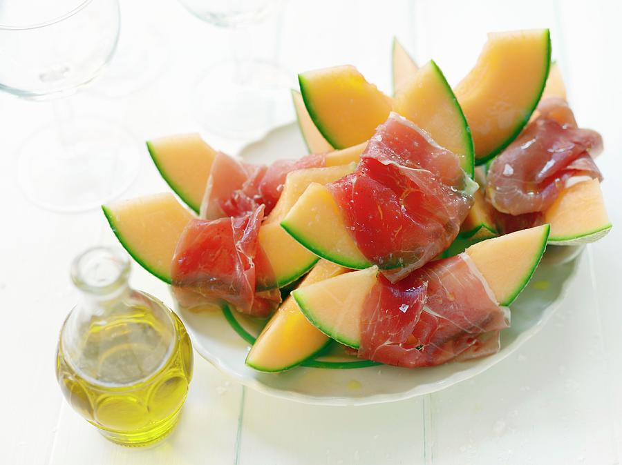 Cantaloupe Melon Wrapped In Ham Photograph by Lina Eriksson