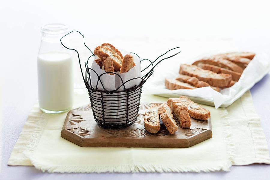 Cantucci In A Wire Basket And On A Chopping Board Photograph by Andrew Young