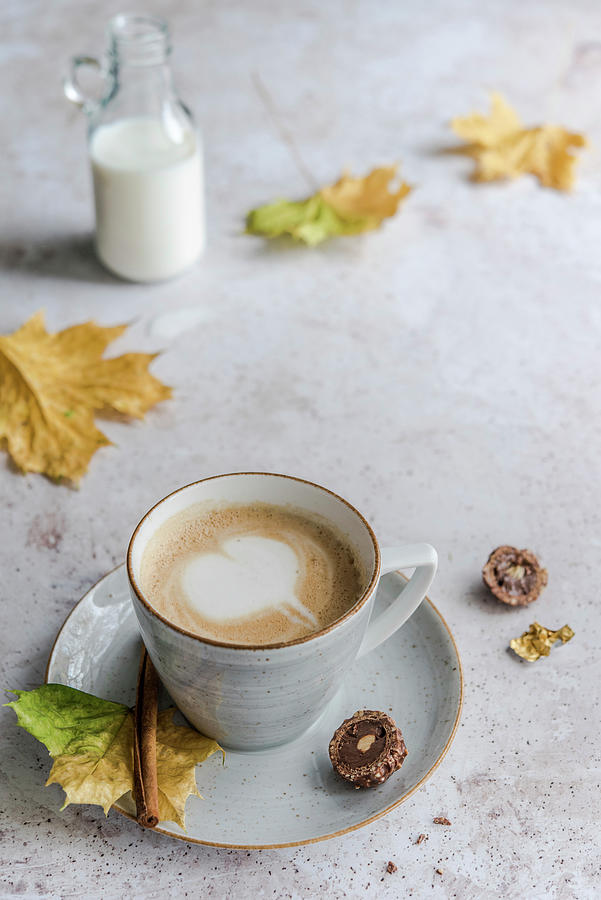Cappuccino With A Milk Foam Heart Surrounded By Autumn Leaves Photograph by Diana Kowalczyk