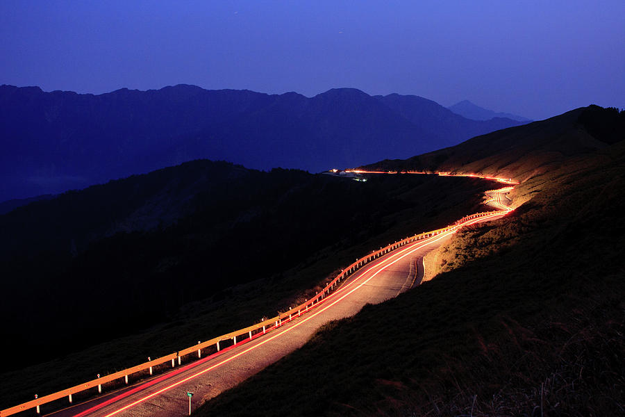 Car Light Trail In Mountain Highway Photograph by Samyaoo