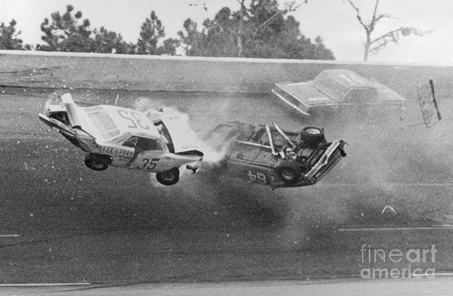 Daytona Beach Photograph - Car Passing Crashing Cars In Race by Bettmann